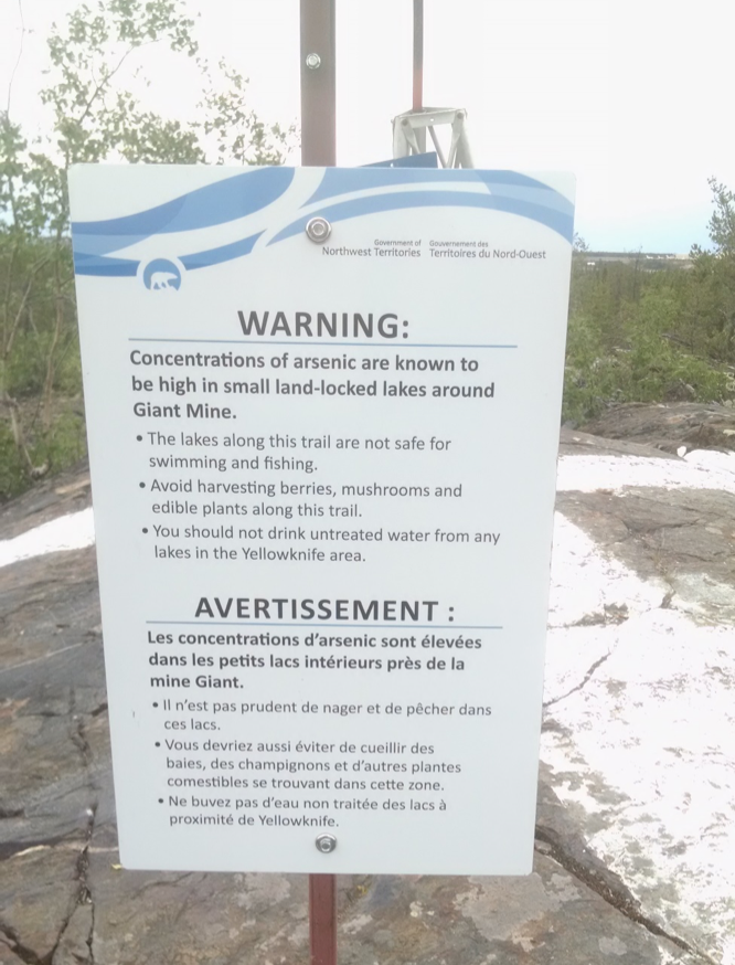 sign warning of arsenic toxicity near a small lake outside of Yellowknife.